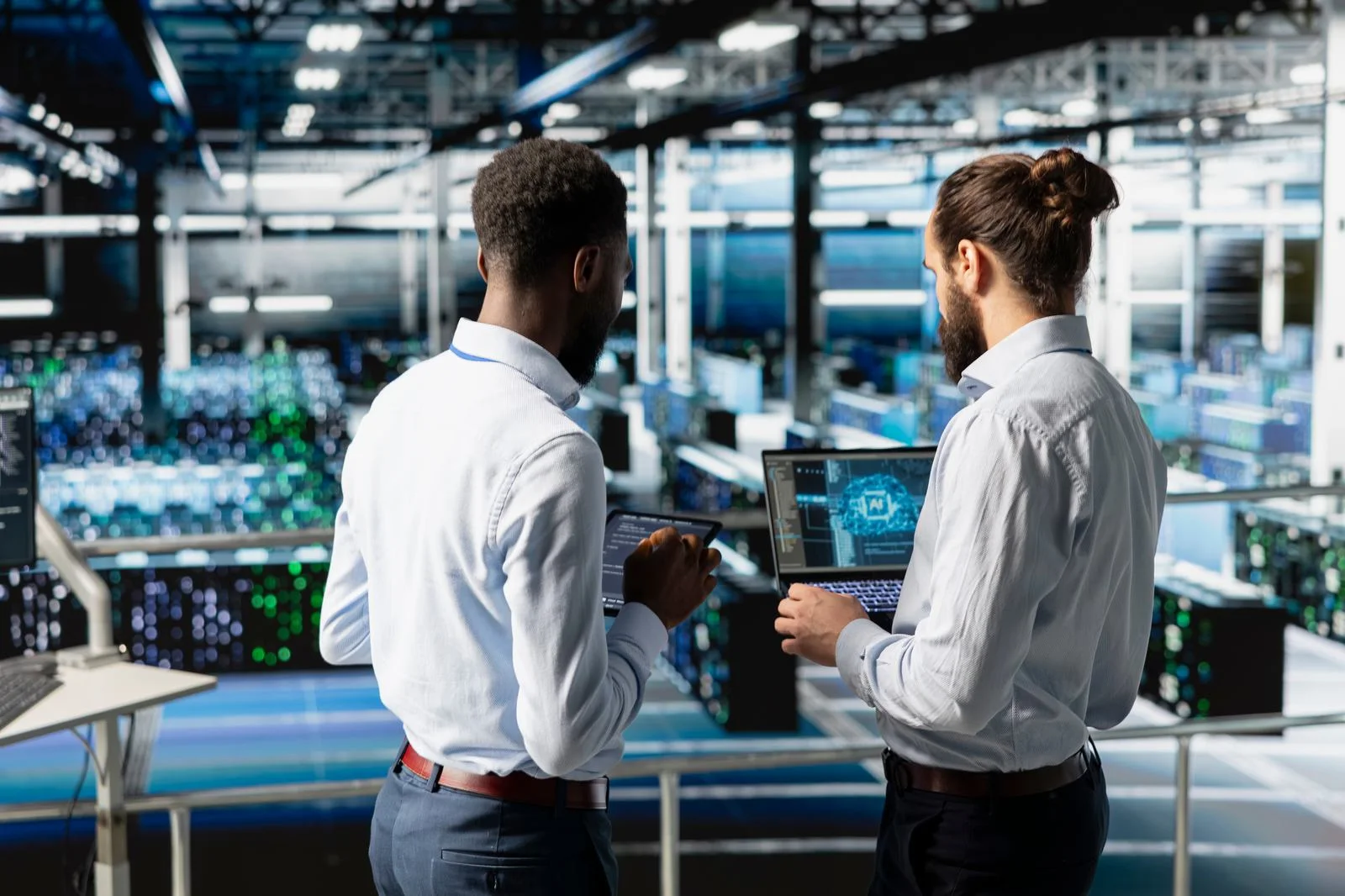 Manufacturing engineers working with digital tools in a modernized factory